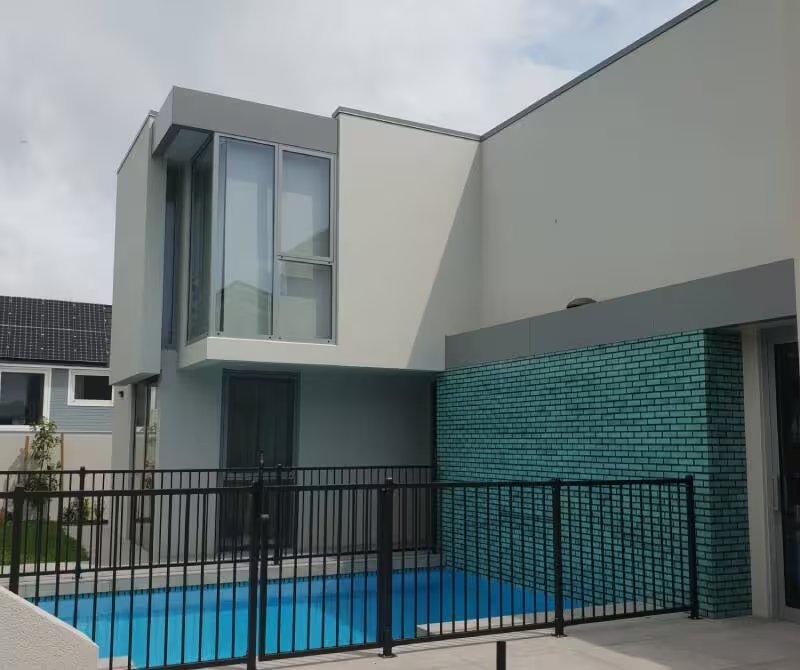 Plaster clad home with pool fence